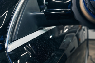 A technician is repairing a damaged side mirror at Heart City Toyota Collision Center in Elkhart, IN.