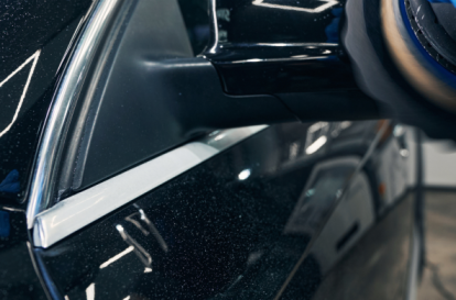 A technician is repairing a damaged side mirror at Heart City Toyota Collision Center in Elkhart, IN.
