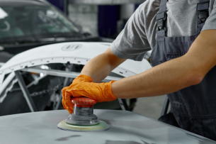 Certified auto body repair technicians working on a Heart City Toyota Collision Center vehicle.