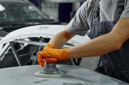 Certified auto body repair technicians working on a Heart City Toyota Collision Center vehicle.